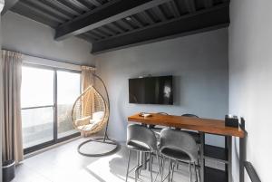 a room with a table and chairs and a tv at 初約旅宿 Meet B&B in Green Island