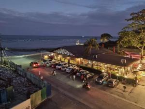 a parking lot with cars parked in front of a building at Wave Crest Retreat at Marina Spatial Dumaguete in Dumaguete