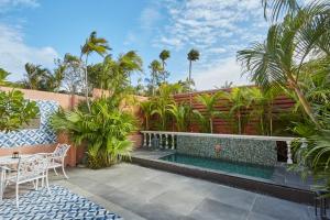 a swimming pool in the backyard of a house at Kenting Amanda Hotel in Nanwan