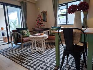 a living room with a table and a christmas tree at Fabulous apartment next to beach and Kalkbay in Fish hoek