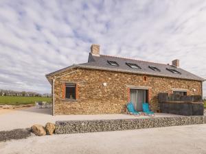 a stone building with two blue chairs in front of it at Gîte au calme avec terrasse, proche Nantes - FR-1-306-1301 in Nort-sur-Erdre