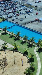 an overhead view of a large pool with a parking lot at Marissa Homestay Jesselton Quay in Kota Kinabalu