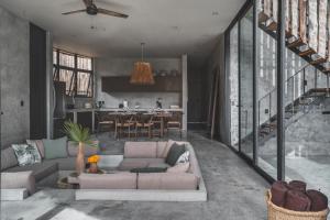 a living room with a couch and a kitchen at Jungle Luxury Villa Pvt Pool 100mbs AC Concierge D9 in Tulum