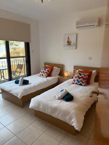 two beds in a room with a balcony at Green valley Tersefanou in Tersephanou +20 photos