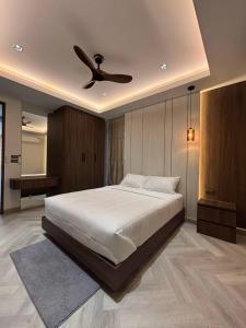 a bedroom with a bed with a ceiling fan at Mountain breeze villa phuket in Ban Bang Khu +67 photos