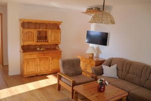 a living room with a couch and a chair at Apartment Haus Stalu 5 guests in Bürchen