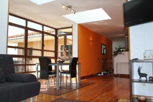 a living room with a dining room table with black chairs at Sierra Pulide Apartamentos in Salinas