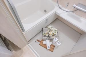 an overhead view of a bathroom with a sink and flowers at DUA 神楽坂Shinjuku area,train 3 mins,waseda,Kagurazaka in Tokyo