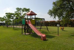 a playground with a slide in a park at Il Girasole in Venturina Terme