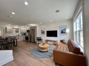 a living room with a couch and a table at Wood House King Bd 2 Queens Fire Pit in St. John's