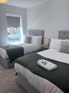 Giường trong phòng chung tại The Ivy Abode 2 bed Apartment +6 ảnh