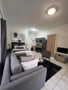 a living room with a couch and a bed at The Lagoon in Pretoria