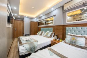 a bedroom with two beds and a tv at Istanbul Sirkeci Hotel in Istanbul