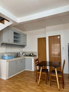 a kitchen and dining room with a table and chairs at Sebastians Crib in Dasmariñas