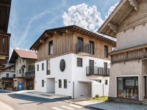 a house with a wooden roof at Apartment in Kirchberg near Ski Lift in Kirchberg in Tirol