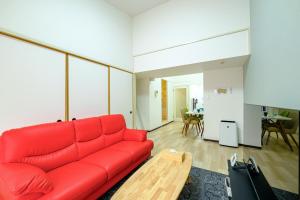 a red couch in a living room with a table at さくらハウス - Sakura house - 広々快適 最大6名滞在可 in Tokyo +51 photos