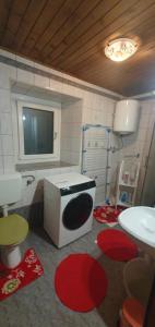 a bathroom with a sink and a tv on the wall at Sigma house in Mojstrana +21 photos