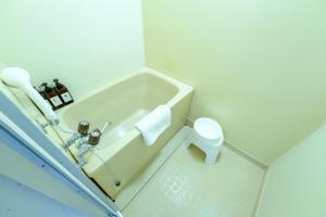 a white bathroom with a tub and a toilet at さくらハウス - Sakura house - 広々快適 最大6名滞在可 in Tokyo