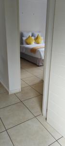 a bedroom with a bed and a tiled floor at Southside in Johannesburg +1 photo