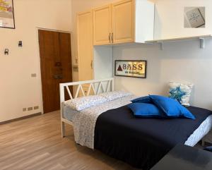 a bedroom with a bed with blue pillows on it at Loft Mazzini Rapallo in Rapallo