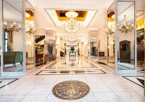 a lobby with mirrors and a sign on the floor at Best Western Premier Grand Hotel Russischer Hof in Weimar