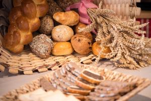 a bunch of different types of bread on a table at Chesa Valese by Sisters Zermatt in Zermatt