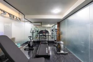 a gym with a treadmill and other equipment in a room at Saltstayz Premier - Paschim Vihar in New Delhi