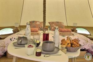a table with a table cloth with food on it at La tente de kergomar in Ploumilliau