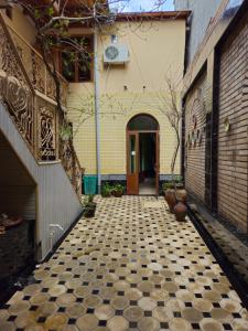 an alley with a tiled floor in front of a building at B&B Bahodir in Samarkand