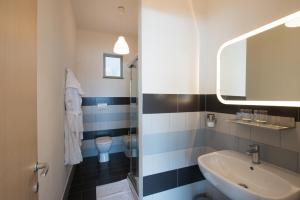 a bathroom with a sink and a toilet at Levante Residence in La Spezia