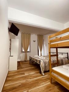a bedroom with two beds and a wooden floor at Garda Havens in Castelnuovo del Garda +60 photos
