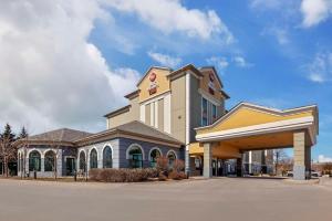 a large building with a gas station at Best Western Plus Executive Inn in Toronto