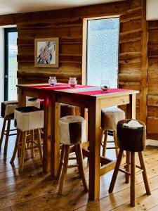 a dining room table with a red cloth on it at Nid cosy avec vue montagne au coeur de saint lary in Saint-Lary-Soulan