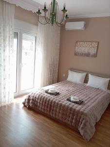 a bedroom with a large bed with two plates on it at Kavala Penthouse in Kavala