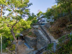 a house on top of a hill with stairs at Cliffpods in Idukki