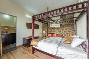 a bedroom with a large bed with a wooden frame at Cliffpods in Idukki