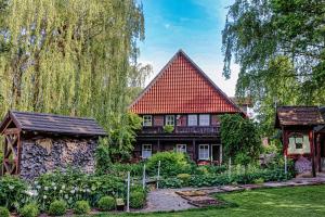 a house with a red roof and a garden at Bauerncafé Sprengel in Bad Gandersheim