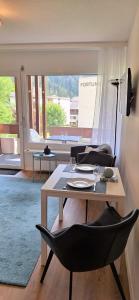 a living room with a table and two chairs at Mayenzett 25, komplett renoviert, vis-à-vis Klinik & Thermalbad in Leukerbad
