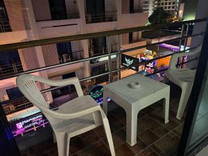 two chairs and a table on a balcony at night at Garden Guest House in Pattaya Central