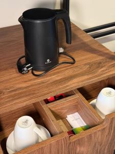 a black pot sitting on top of a wooden drawer at Rahat Palace Hotel in Almaty