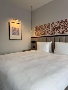 a bedroom with a large bed with white sheets at Rahat Palace Hotel in Almaty +67 photos