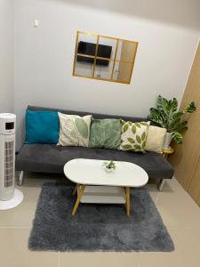 a living room with a couch and a table at Theodore Alfonzo rental in Manila