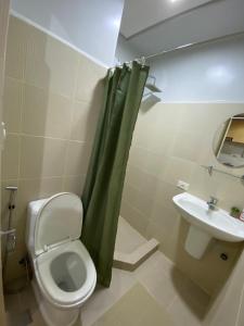 a bathroom with a toilet and a sink at Theodore Alfonzo rental in Manila