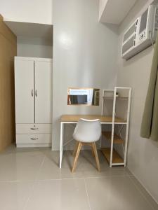 a room with a desk and a white chair at Theodore Alfonzo rental in Manila