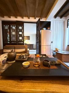 a kitchen with a table with bowls of food on it at Dali Wenshuo Ancient City Center Private Courtyard Hotel in Dali Ancient Town