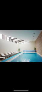 a large swimming pool with chairs and a swimming pool at Aspen golf studio B402 in Razlog