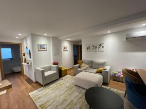 a living room with a couch and a chair at Casa do Ferreiro T3 in Venda Nova