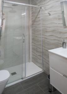 a shower with a glass door in a bathroom at Fogar Bardanca in Melide +21 photos