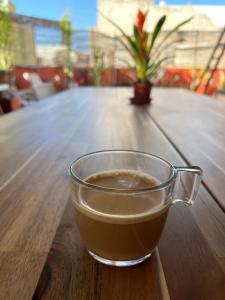 a cup of coffee sitting on a wooden table at Ático Sol Vecindario in Vecindario
