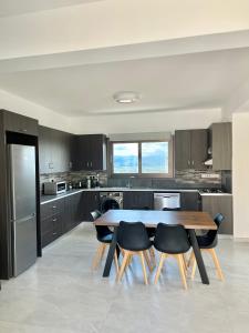 a kitchen with a table and chairs in it at Villa Terra Rosa in Kritou Terra